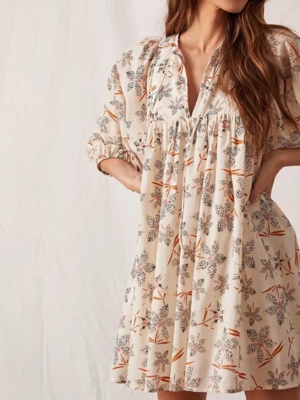 Anthropology Caballero off-white floral babydoll dress features 3/4 sleeves.
